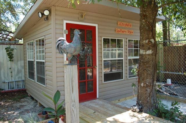 A chicken coop with a red door.