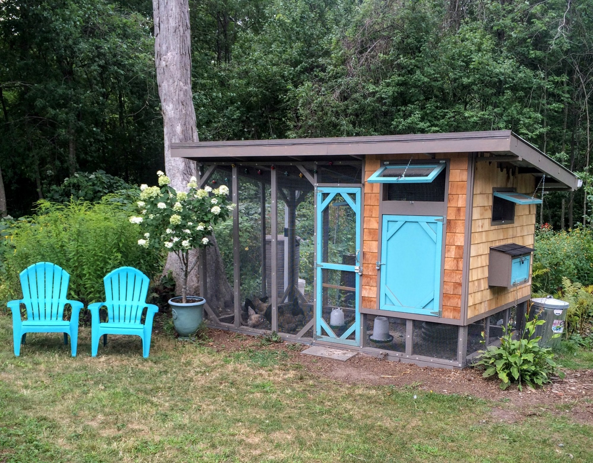 backyard garden style chicken coop with small run and decorative outdoor setup